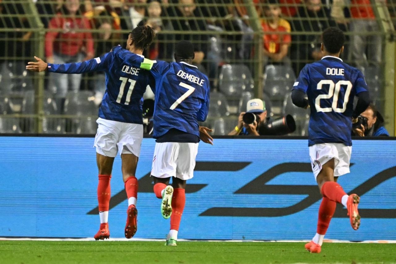 France's midfielder #11 Michael Olise (L) celebrates with France's forward #07 Ousmane DembÈlÈ (C) after scoring the opening goal during the UEFA Nations League Group A1 football match between Belgium and France at King Baudouin Stadium in Brussels on September 28, 2026. (Photo by NICOLAS TUCAT / AFP)